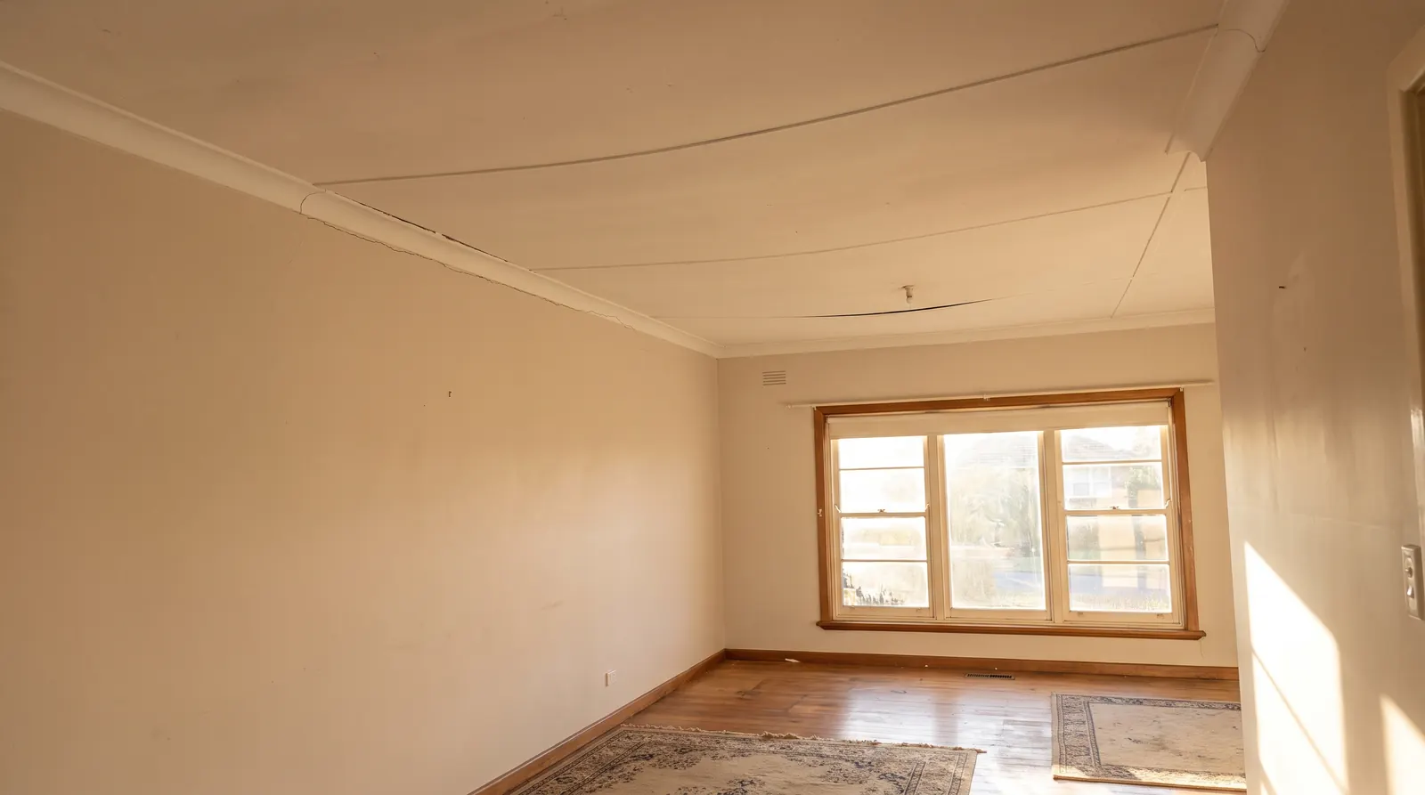 Sagging ceiling with a visible bow and cornice crack in an older Perth home