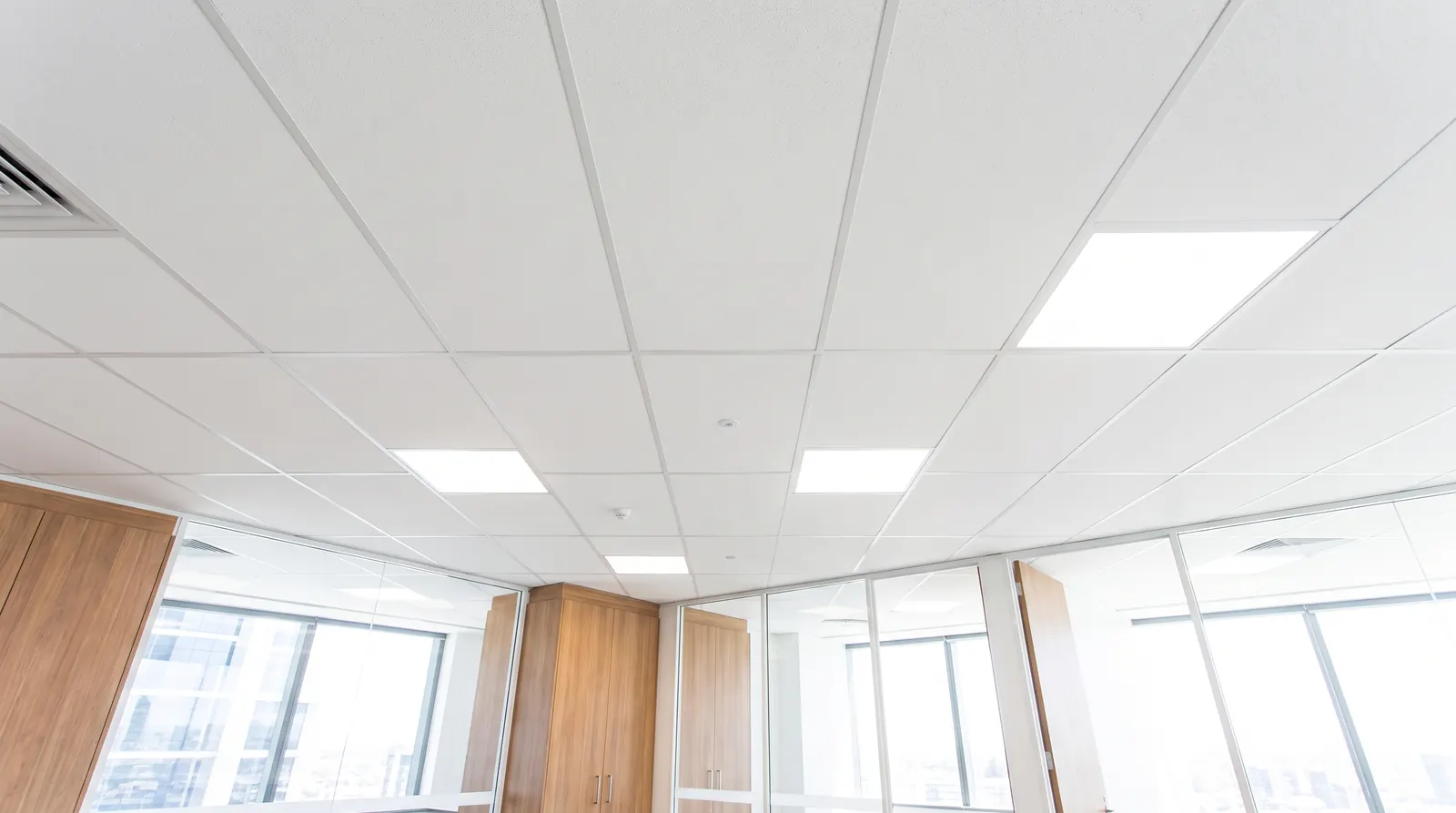 Freshly installed suspended grid ceiling with LED panels above a Perth office fitout